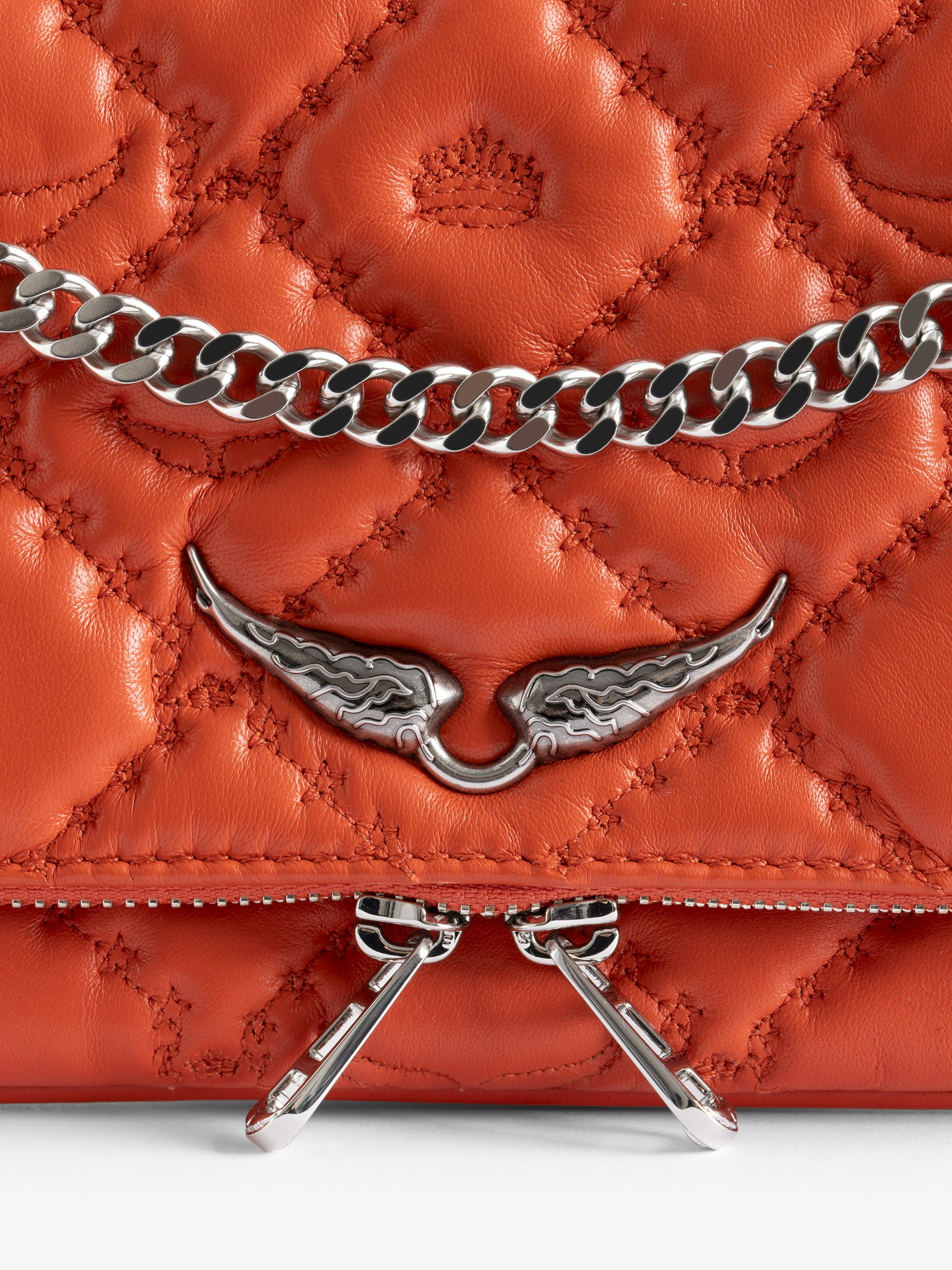 Rock II Quilted Monogram Clutch - Clutch in smooth quilted leather with sliding metal chain and signature wings.